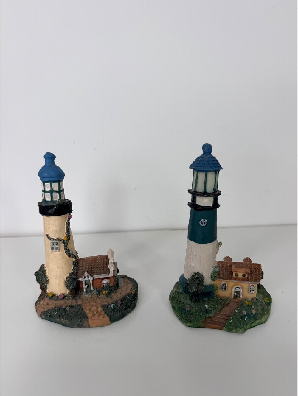 Set of 2 resin lighthouse figurines with cottage base
